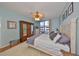 Bright bedroom with a ceiling fan, light blue walls, and sliding glass door to the balcony at 1 Beach Se Dr # 811, St Petersburg, FL 33701