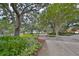 Serene exterior view showcasing a well-maintained pathway amidst lush landscaping and mature trees in a quiet community at 1 Beach Se Dr # 811, St Petersburg, FL 33701