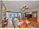Bright living room with parquet floors, large windows, ceiling fan, and comfortable furniture at 1 Beach Se Dr # 811, St Petersburg, FL 33701