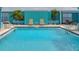 Rooftop pool with lounge chairs for relaxing in a modern condominium complex overlooking ocean views at 1 Beach Se Dr # 811, St Petersburg, FL 33701