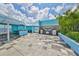 Open roof deck area with outdoor cooking facilities including grills and picnic-style seating under a covered trellis at 1 Beach Se Dr # 811, St Petersburg, FL 33701