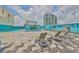 Rooftop deck with city views, lounge chairs and tables, and pool area overlooking the city and ocean at 1 Beach Se Dr # 811, St Petersburg, FL 33701