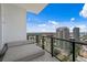 City view from balcony featuring daybed, glass railing, and tile flooring on a sunny day at 100 1St N Ave # 3905, St Petersburg, FL 33701