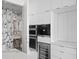 Modern bathroom with unique patterned wallpaper, gold accents, and a stylish sink at 100 1St N Ave # 3905, St Petersburg, FL 33701