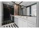 Modern bathroom featuring double sinks, a large mirror, and a stylish glass-enclosed shower with black and white tile at 100 1St N Ave # 3905, St Petersburg, FL 33701