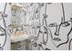 Close-up of a modern bathroom with unique patterned wallpaper, gold accents, and a stylish sink at 100 1St N Ave # 3905, St Petersburg, FL 33701