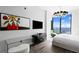 Bedroom with a modern art piece, TV, desk, and a stunning ocean view from the expansive window at 100 1St N Ave # 3905, St Petersburg, FL 33701