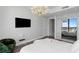 Bright bedroom with a city view features a modern chandelier and wardrobe with mirrored doors at 100 1St N Ave # 3905, St Petersburg, FL 33701