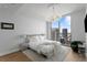 Modern bedroom featuring cityscape views, large window, stylish chandelier, and neutral colors at 100 1St N Ave # 3905, St Petersburg, FL 33701