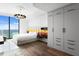 Bright bedroom featuring wood floors, a modern chandelier, and a large window with a beautiful ocean view at 100 1St N Ave # 3905, St Petersburg, FL 33701