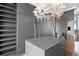 Spacious closet featuring custom cabinets, a decorative chandelier, and a convenient ladder for accessing upper storage at 100 1St N Ave # 3905, St Petersburg, FL 33701