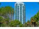 Striking high-rise building with modern architecture, surrounded by lush greenery and clear blue sky at 100 1St N Ave # 3905, St Petersburg, FL 33701