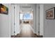 Bright hallway with wood flooring and artwork leading to living area with floor-to-ceiling windows at 100 1St N Ave # 3905, St Petersburg, FL 33701