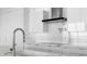 Modern kitchen with stainless steel faucet, white marble countertops and backsplash and sleek white cabinetry at 100 1St N Ave # 3905, St Petersburg, FL 33701