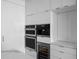 Modern kitchen with stainless steel appliances, including built-in ovens, and sleek white cabinetry at 100 1St N Ave # 3905, St Petersburg, FL 33701