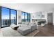 Stylish living room with modern furnishings, fireplace, and balcony access overlooking the ocean at 100 1St N Ave # 3905, St Petersburg, FL 33701