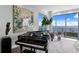 Elegant living room featuring a grand piano and floor-to-ceiling windows with stunning water views at 100 1St N Ave # 3905, St Petersburg, FL 33701