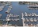 Aerial view of a marina showcasing numerous boats docked in calm, blue waters with nearby buildings and greenery at 100 1St N Ave # 3905, St Petersburg, FL 33701
