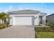 Beautiful one-story home featuring a brick paver driveway and manicured landscaping at 10482 Sea Breeze Ridge Dr, Englewood, FL 34223