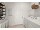 Well-organized laundry room with modern washer, dryer, and storage solutions at 10482 Sea Breeze Ridge Dr, Englewood, FL 34223