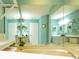 Bright bathroom featuring dual sinks, a soaking tub, and ample mirror space at 112 Sun Isle Cir # 112, Treasure Island, FL 33706