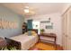 Cozy bedroom with light walls, a ceiling fan, wooden floors, and bright window at 112 Sun Isle Cir # 112, Treasure Island, FL 33706