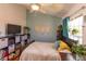Comfortable bedroom featuring a bed, storage cubes, and bright window at 112 Sun Isle Cir # 112, Treasure Island, FL 33706