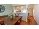 Dining room with wood floors, a view to the kitchen, and a unique tree decoration at 112 Sun Isle Cir # 112, Treasure Island, FL 33706