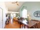Open-concept living room with vaulted ceilings, wood floors, and large bright windows at 112 Sun Isle Cir # 112, Treasure Island, FL 33706