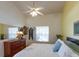 Bright primary bedroom with a ceiling fan and dresser storage at 112 Sun Isle Cir # 112, Treasure Island, FL 33706
