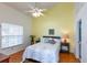 Bright primary bedroom with a ceiling fan and an ensuite bath at 112 Sun Isle Cir # 112, Treasure Island, FL 33706