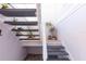 Staircase to the house with a white railing and potted plants at 112 Sun Isle Cir # 112, Treasure Island, FL 33706