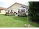 Beautiful backyard features a lush lawn, mature landscaping, and a patio area perfect for outdoor relaxation at 11323 Highlander Ct, Spring Hill, FL 34609