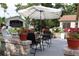 A patio is furnished with a table and chairs, accented by potted plants and decorative statues at 11323 Highlander Ct, Spring Hill, FL 34609
