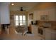 Eat-in kitchen features white cabinetry, neutral countertops and backsplash, and ample natural light at 11323 Highlander Ct, Spring Hill, FL 34609