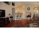 Open-concept living area features hardwood floors with access to the kitchen at 11323 Highlander Ct, Spring Hill, FL 34609