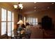A well-lit living room features a glass-top table, sofas, and large windows with plantation shutters at 11323 Highlander Ct, Spring Hill, FL 34609
