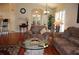 Comfortable living room with hardwood floors and plush furniture, perfect for relaxation and entertaining at 11323 Highlander Ct, Spring Hill, FL 34609