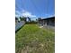 Spacious backyard with lush green grass and a white fence at 11423 77Th Ave, Seminole, FL 33772