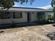 Charming single-story home featuring an inviting front porch and mature landscaping, and solar panels at 11423 77Th Ave, Seminole, FL 33772