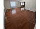 Bright living room featuring hardwood floors and natural light from a large window at 11423 77Th Ave, Seminole, FL 33772