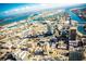 Aerial view of a coastal city with skyscrapers and waterways under a blue sky at 115 White Marsh Ln, Rotonda West, FL 33947