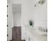 Bright bathroom with quartz counters, white cabinets, undermount sink and view to an adjacent room at 115 White Marsh Ln, Rotonda West, FL 33947