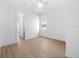 Empty bedroom with hardwood-style floors, ceiling fan, a window, and a closet to the left at 115 White Marsh Ln, Rotonda West, FL 33947