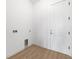 Clean laundry room with hook ups for washer/dryer, vinyl flooring, and a white door to the right at 115 White Marsh Ln, Rotonda West, FL 33947