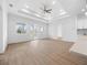 Bright living room featuring wood floors, multiple windows, and an open floor plan at 115 White Marsh Ln, Rotonda West, FL 33947