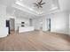 Bright and airy living room with recessed lighting, an open kitchen view, and sleek, wood-look flooring at 115 White Marsh Ln, Rotonda West, FL 33947
