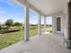 Covered patio features white columns with a view of the canal and greenery at 115 White Marsh Ln, Rotonda West, FL 33947