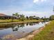 Scenic waterfront view of the canal with wildlife and lush landscaping surrounding homes at 115 White Marsh Ln, Rotonda West, FL 33947