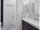 Bathroom with single vanity, granite countertops, decorative mirrors, and modern fixtures at 11617 Crowned Sparrow Ln, Tampa, FL 33626